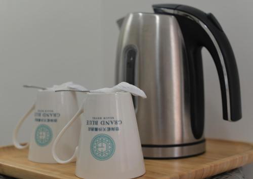 a coffee pot and two mugs on a counter at Grand Blue Beach Hotel in Boracay