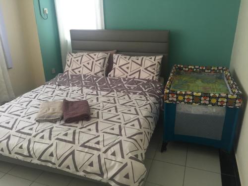 a bedroom with a bed and a table at Apartment in Kumbang Pasang BSB in Bandar Seri Begawan
