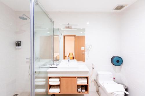 a bathroom with a sink and a shower at Prague Saigon Airport Hotel in Ho Chi Minh City