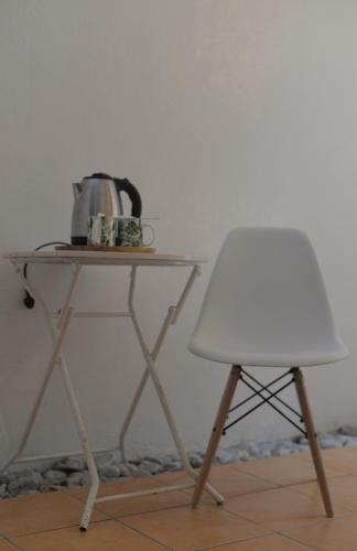 a table with a tea kettle and a chair at Grand Blue Beach Hotel in Boracay