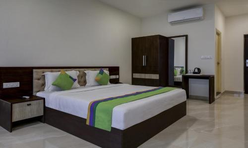 a bedroom with a large bed in a room at Treebo The Horizon Kankanady in Mangalore