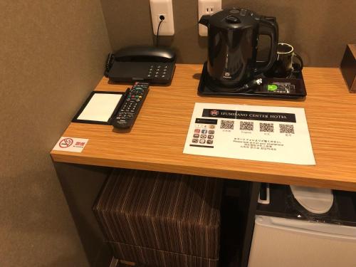 a desk in a hotel room with a coffee maker at Izumisano Center Hotel Kansai International Airport in Izumi-Sano