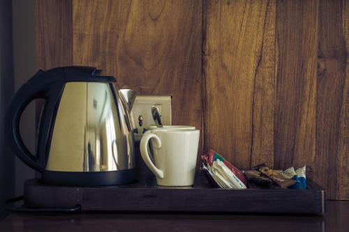 a coffee pot and a cup on a shelf at Kings Landing Unawatuna in Unawatuna