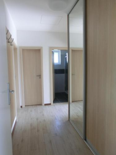 an empty hallway with a mirror in a room at Black Bridge Hotel Apartment in Prague