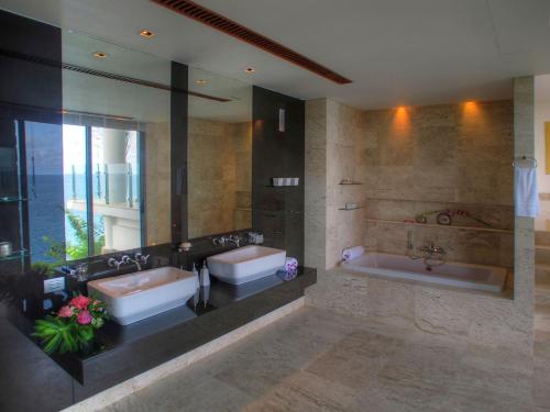 a bathroom with two sinks and a bath tub at Villa Minh in Kamala Beach
