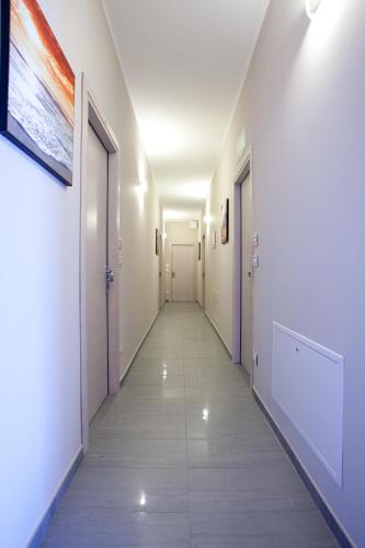 a hallway of a hospital with white walls and doors at Motel Karibe in Fratta Polesine