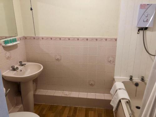 a bathroom with a sink and a toilet and a shower at Reading Budget Apartments in Reading