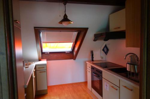a kitchen with a sink and a window in it at Ferienwohnung Panorama in Wertheim