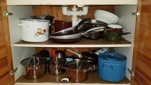 a shelf filled with pots and pans and a sink at Slovak cottage near Bratislava in the heart of the Carpathians in Modra