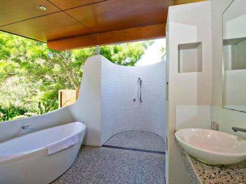 a white bathroom with a tub and a sink at Kingfisher in Margaret River Town