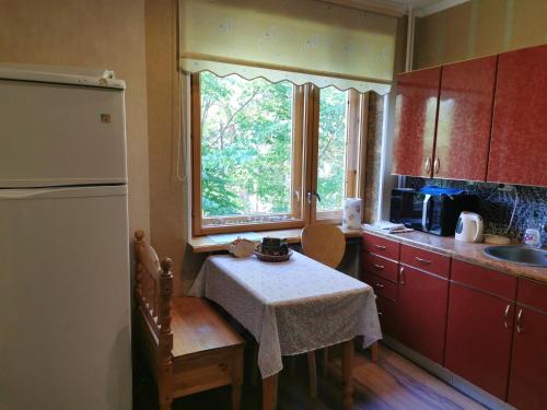 a small kitchen with a table and a window at 12 Pargi in Narva-Jõesuu