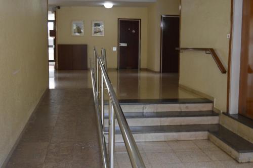 a hallway with stairs in a building with a door at Vallparadis apartment in Terrassa