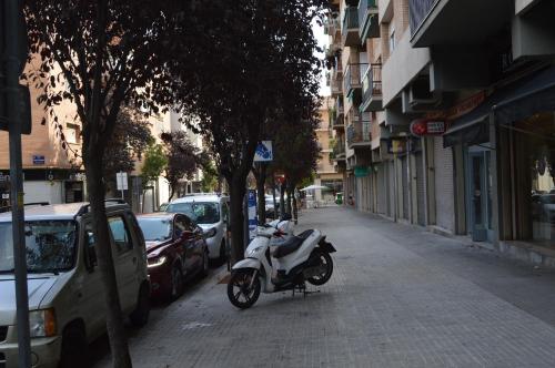 a motorcycle parked on the side of a street at Vallparadis apartment in Terrassa