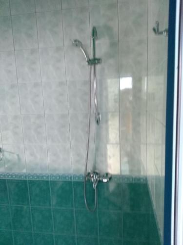 a shower with a glass door in a bathroom at The Colourful Mansion Hotel in Ahtopol