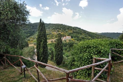 a view from a hill with a fence and trees at La Casa nel Castello di Gaiche in Piegaro