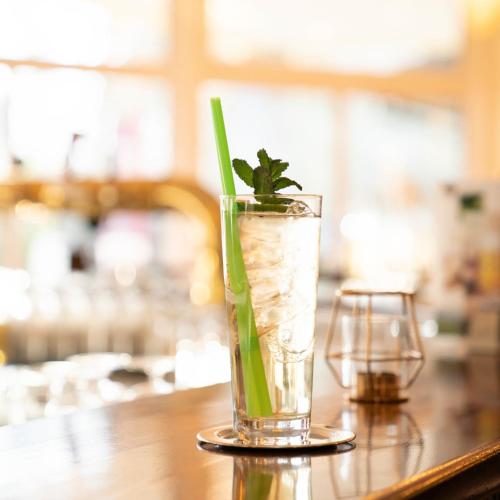 a glass with a plant in it on a table at Hotel Löwenstein in Gerolstein