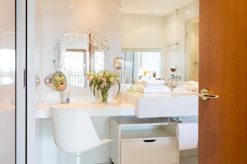 un bagno con un lavandino bianco e uno specchio di Hotel & Spa Der Steirerhof a Bad Waltersdorf