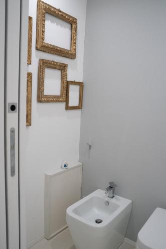 a bathroom with a white toilet and a sink at Acquabianca in Aci Castello