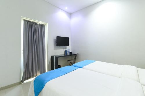 Кровать или кровати в номере Hotel Berlian International