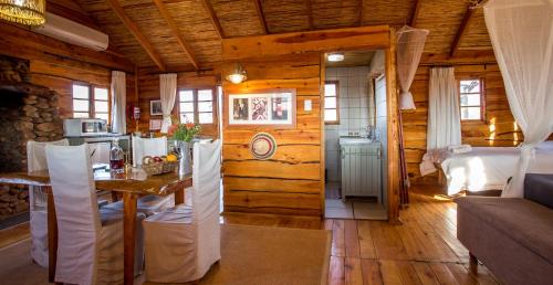 a room with a bedroom and a kitchen with a table at Soetdoring Selfsorg in Oudtshoorn