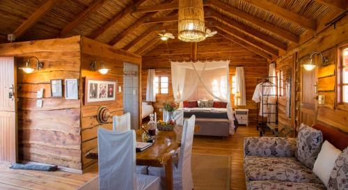 a living room with a table and chairs and a couch at Soetdoring Selfsorg in Oudtshoorn
