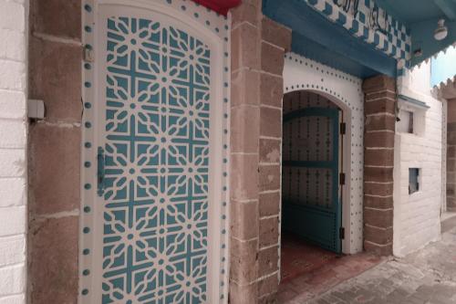 an entrance to a building with a blue and white door at Riad Beldy in Essaouira
