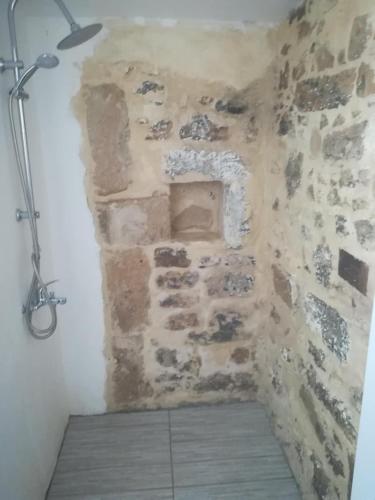 a corner of a room with a stone wall at Kritikies Lasea in Pitsidia