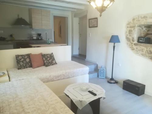a living room with a couch and a table at Kritikies Lasea in Pitsidia