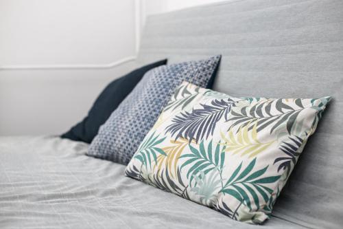 a bed with two pillows on top of it at Rooms4Less in Gdańsk