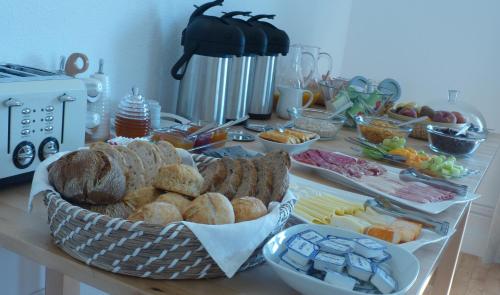 a table topped with a basket of bread and other foods at Comfy Sintra in Sintra