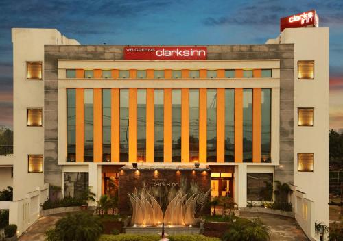 a building with a fountain in front of it at M B Greens Clarks Inn in Morādābād