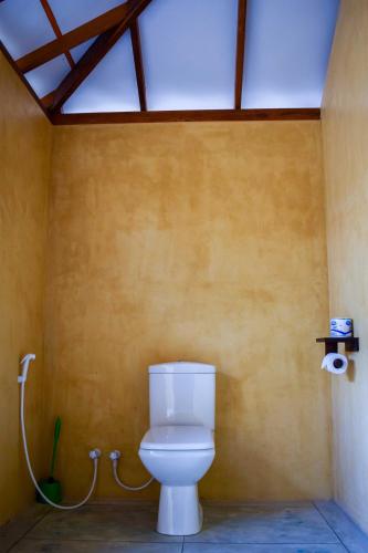 a bathroom with a toilet in a room at Omeesha Beach Hotel in Kalpitiya