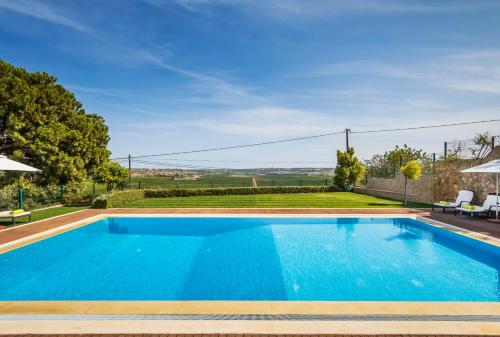a swimming pool in the backyard of a house at Vila Odysseus in Alcantarilha