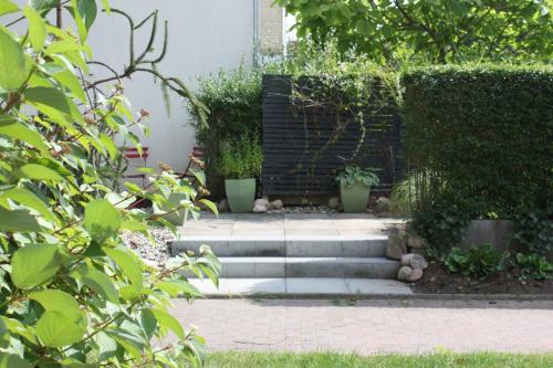 a garden with a set of stairs and plants at Susanne Hendus in Neustadt in Holstein