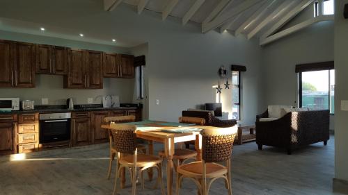 a kitchen with a table and chairs in a room at Sunset Lagoon in Port Nolloth