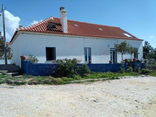 a white house with a red roof at CASA DA LAGINHA in Zambujeira do Mar