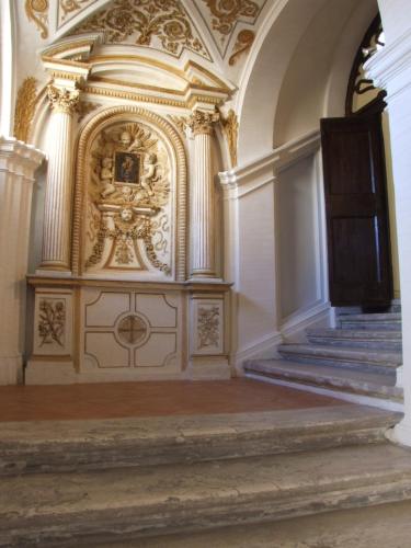 an ornate room with a staircase and a gold door at Donna Camilla Savelli - VRetreats in Rome