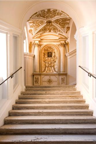 a staircase in a building with a gold ceiling at Donna Camilla Savelli - VRetreats in Rome