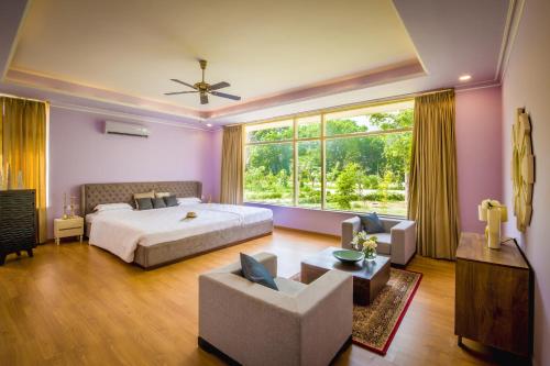 a bedroom with a bed and a large window at Rose Amer in Jaipur