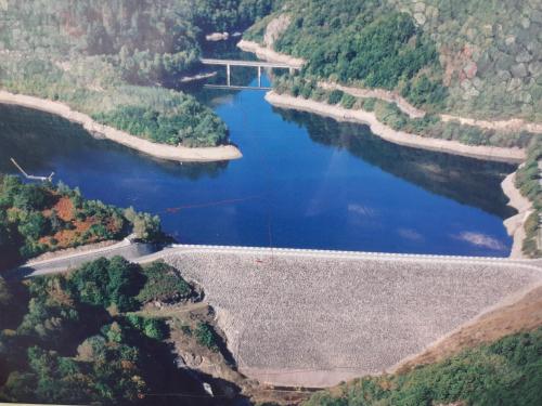 an aerial view of a river with a bridge at Ma villa au bord de l'eau in Miremont
