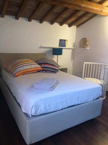 a bedroom with a bed with a white sheets and pillows at Maison Elodie in Narni