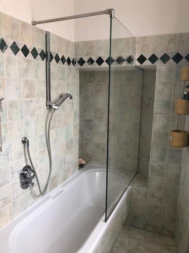 a bathroom with a bath tub with a shower at Maison Elodie in Narni