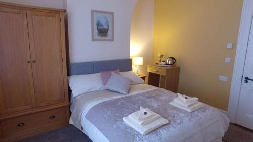 A bed or beds in a room at The Rose Luxury Self Catering Accommodation