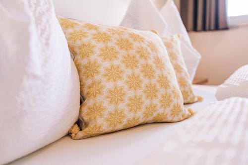 a group of pillows sitting on a bed at Egarter in Appiano sulla Strada del Vino