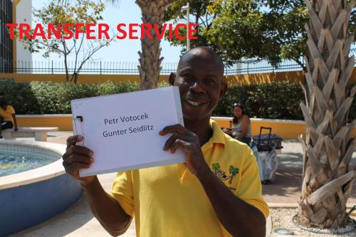 a man holding a sign in front of a pool at Lagoon Ocean Resort in Lagun