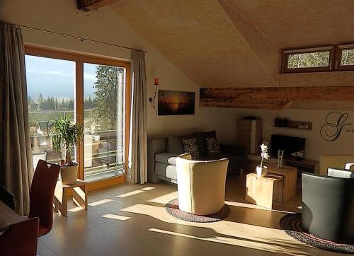 a living room with a couch and a large window at Ferienhaus Bella Vista in Presseggersee