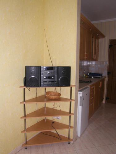 a kitchen with a microwave sitting on a shelf at Park Sétány Apartman in Balatonlelle