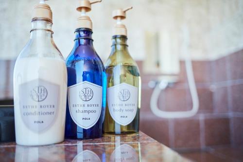 three bottles of wine sitting on top of a counter at Resort villa miko in Oshima