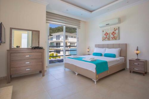 a bedroom with a bed and a large window at ORKA RESIDENCE VILLA 3 in Oludeniz