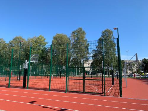a tennis court with a net on a tennis court at Excelent apartment with garden and free parking in Rīga